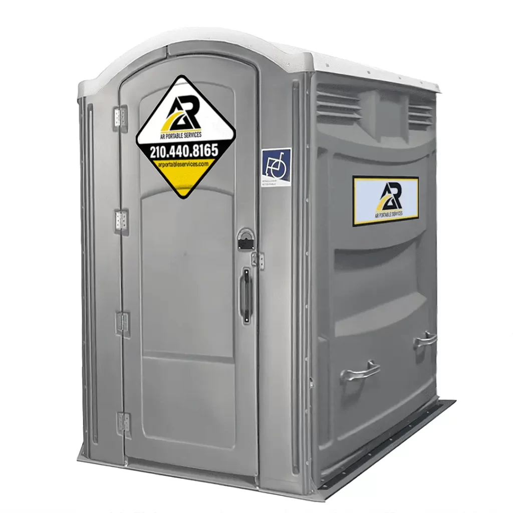 A gray portable restroom with wheelchair accessibility